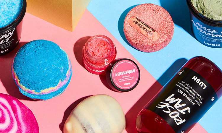 lush's bestselling bath and shower products laid out on a pink and blue surface